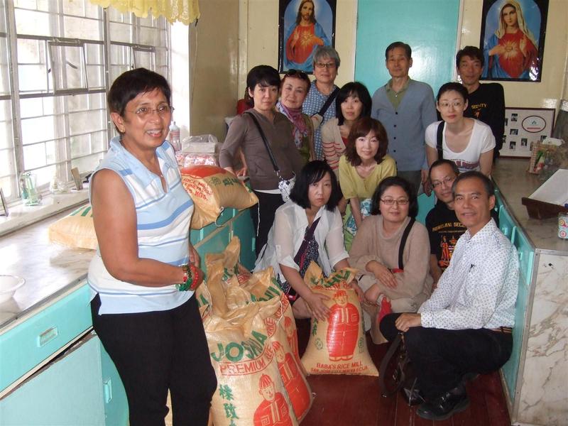 07Guests from Japan with donated rice.jpg